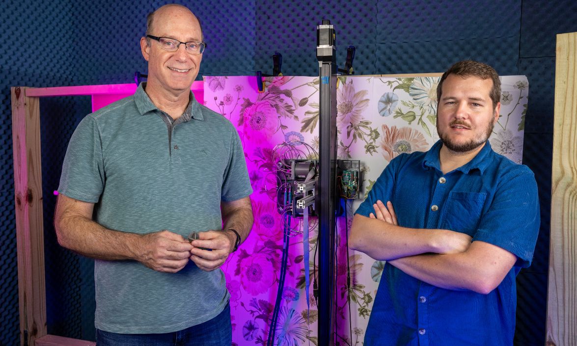 David Smith (left) and Aaron Diebold (right) demonstrate a metamaterial-based microwave imaging system that can visualize hidden structures behind walls